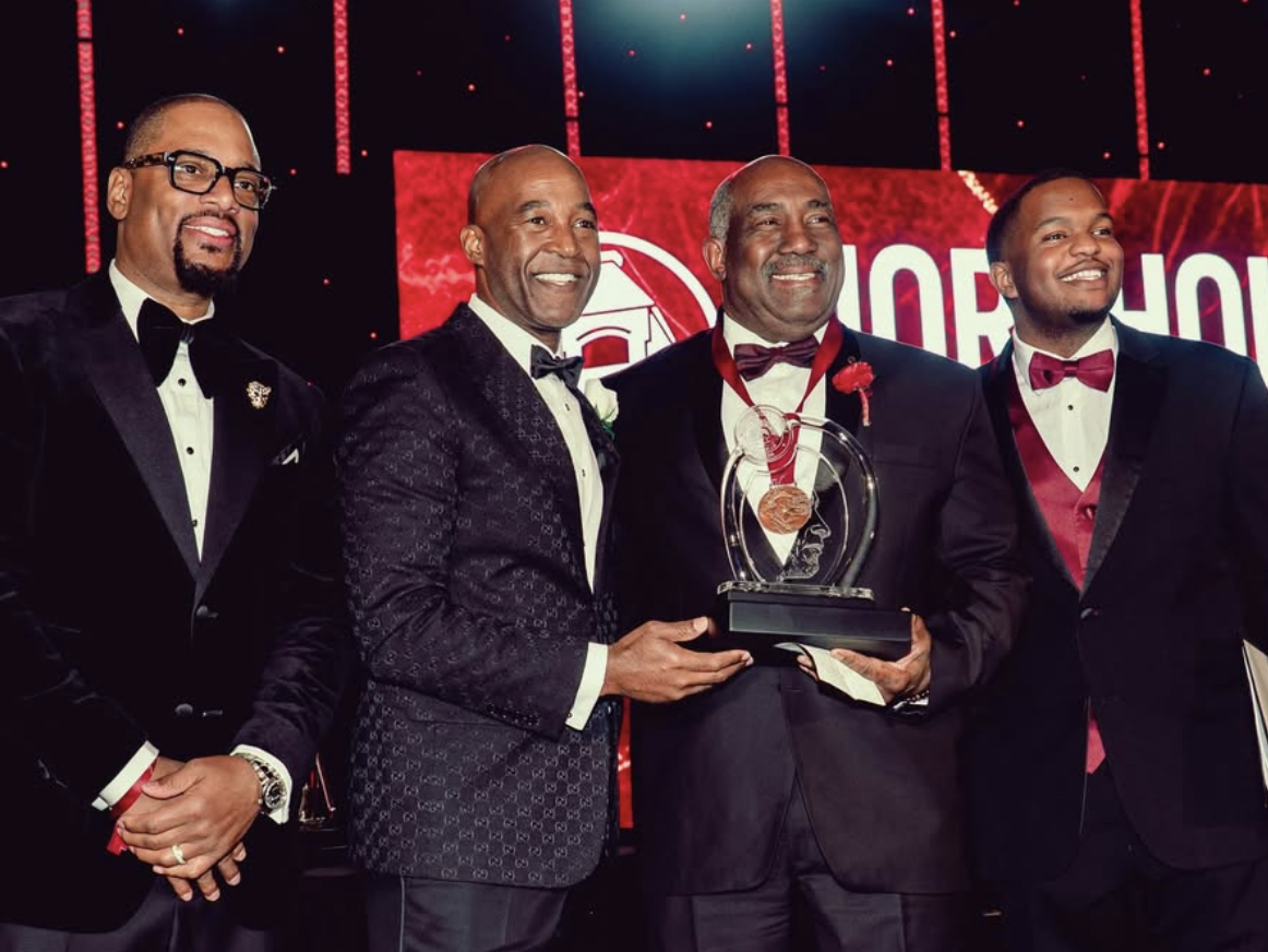 Honoree receiving an award on stage at the 38th Annual A Candle in the Dark Gala
